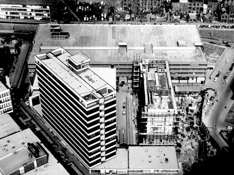 A bird's eye view of the partially completed Merrion Centre in April 1965. Merrion Way is on the right, Merrion Street on the left. Wade Lane is running left to right in front of the centre.