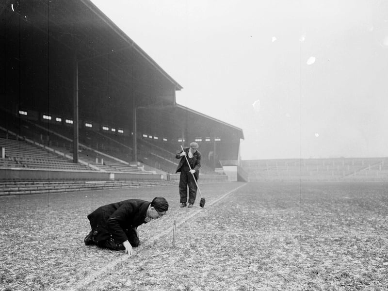 The groundsman takes the temperature of the pitch at Murrayfield in December 1957.