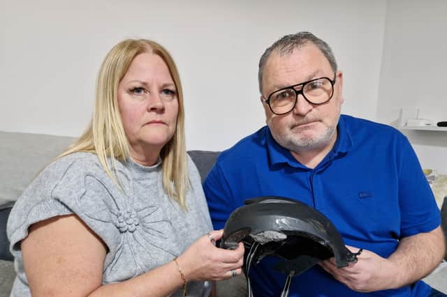 Alison, left, and Jason Twibell, right, of Oughtibridge, with the helmet which Jason was wearing when he was seriously injured when he fell from his bike on tram tracks on Middlewood Road, Sheffield. Photo: David Kessen, Iconic Media