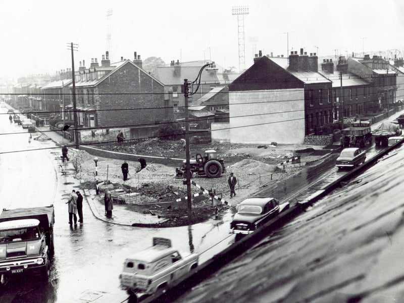 Work to change the layout at the corner of Penistone Road and Parkside Road, Sheffield, in June 1961, with the lighting towers of Sheffield Wednesday's Hillsborough football stadium visible in the background