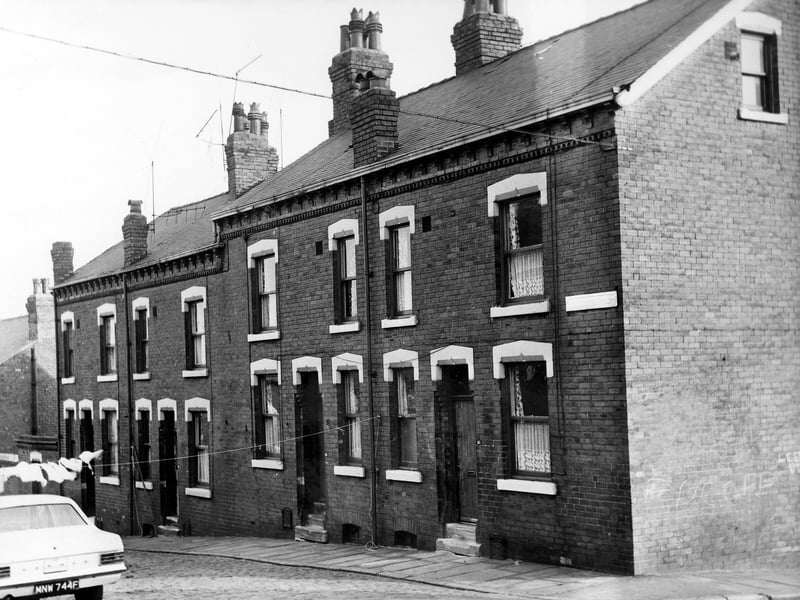 This early 1970s image of Winchester Street shows a row of double fronted back-to-back terraced houses with a shared outside toilet block on the left and Elsworth Street on the right. Clothes hang on a line stretched across the street from outside number 47 on the right.