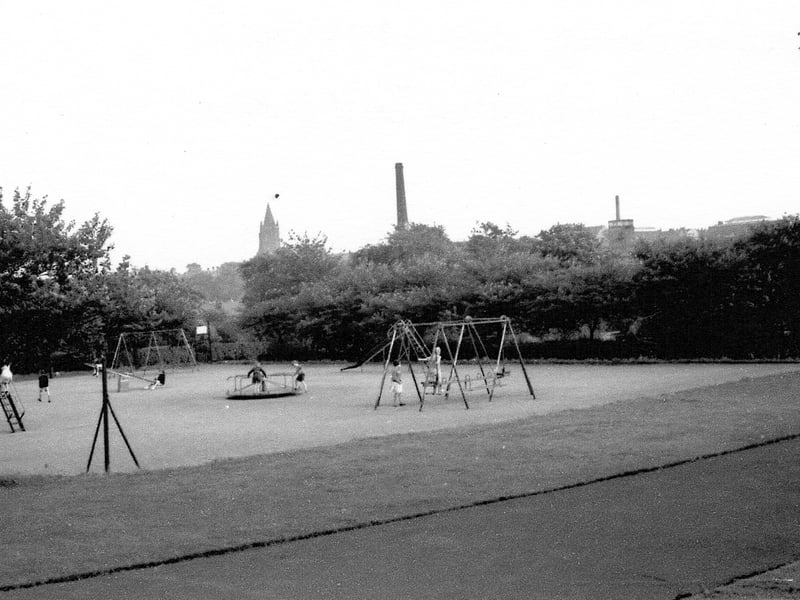 A view of the playground at Armley Park circa 1970s. St Bartholomew's church spire can be seen in the background.