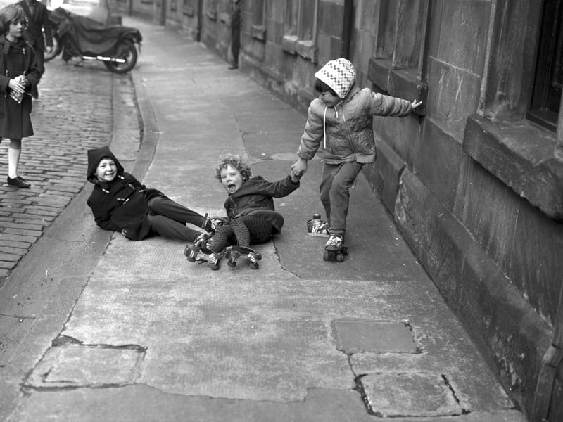 Helen Sutherland, Elaine Turnbull and Susan Evan learning to roller skate in Waverley Park at Abbeyhill, Edinburgh, December 1967.