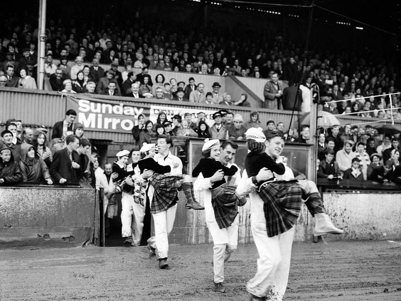 Russian Speedway riders at Old Meadowbank in July, 1961, carry Scottish Country Dancers onto the pitch.