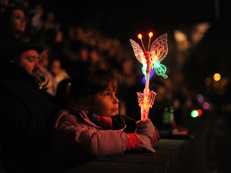 Five year old Sara Bensadik is illuminated as she gazes up at the Meadowbank Fireworks Display in November, 2012.