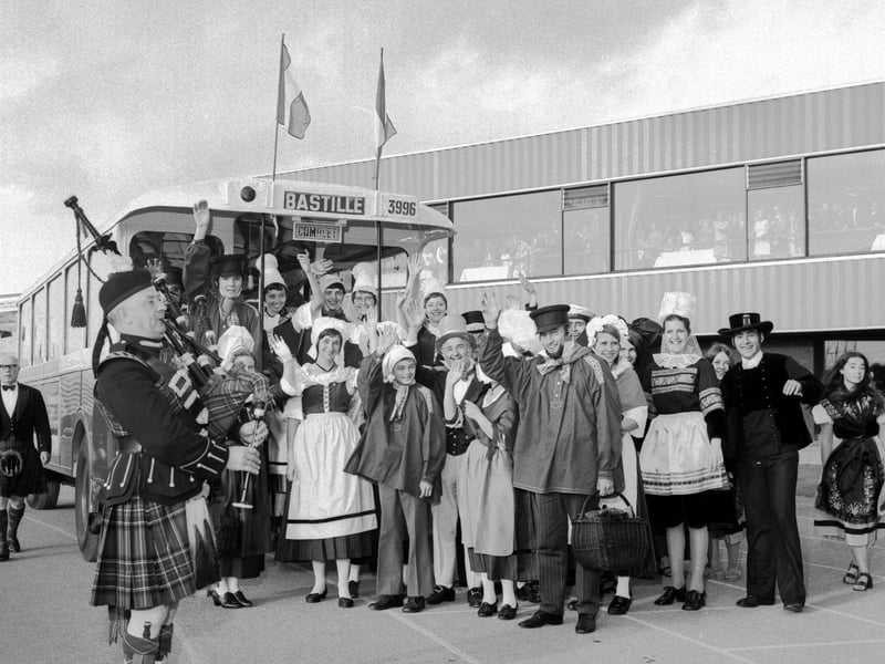 French visitors in national costume travelled from Paris in an old bus to Edinburgh for the Bastille Day celebrations in July 1971. They were greeted by a piper at Meadowbank stadium.