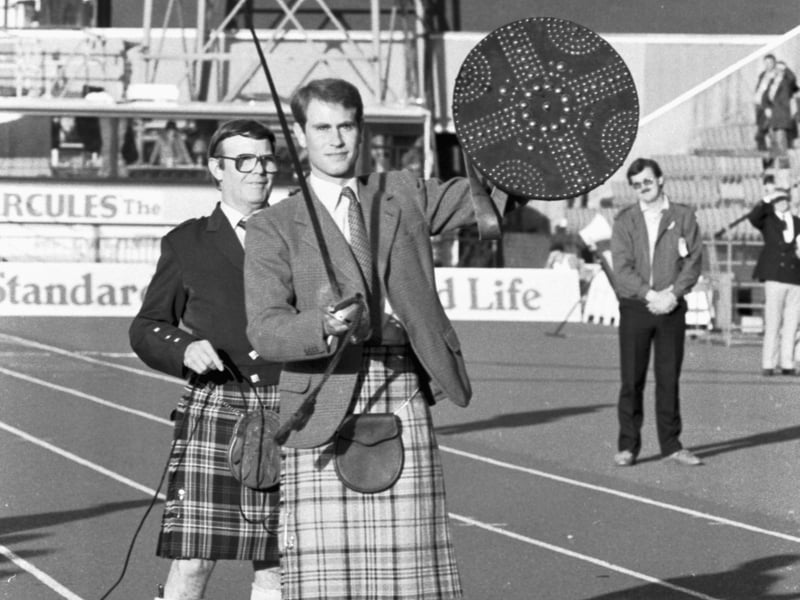 In his role as Chieftain, Prince Edward beats the champion's shield with a sword to officially open the Standard Life Commonwealth Highland Games at Meadowbank Stadium in July 1986.
