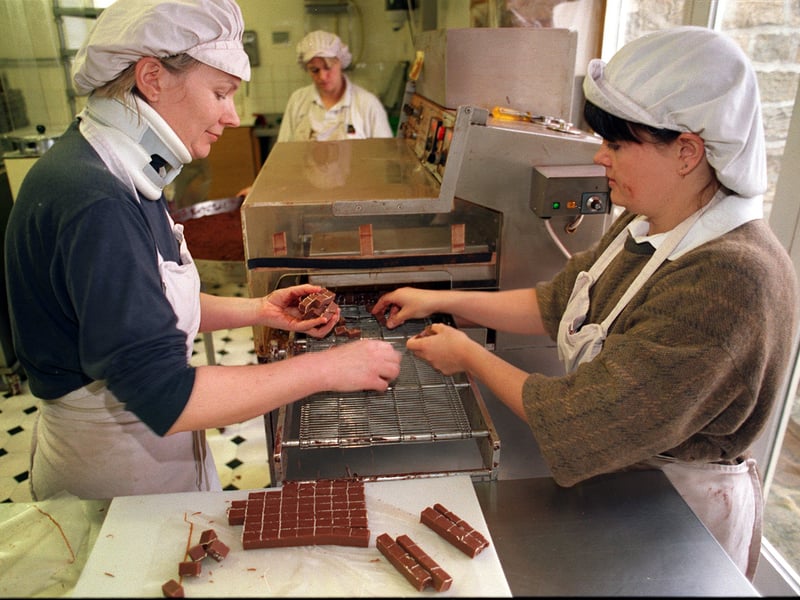 Nicola Porter and Nicola O'Leary load truffles on the conveyor belt at the factory farm of the Chocolate Society, near Otley, in 1995