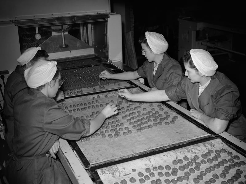 Women decorating chocolates on the production line at the Nestle factory, Hayes, Middlesex, in November 1953
