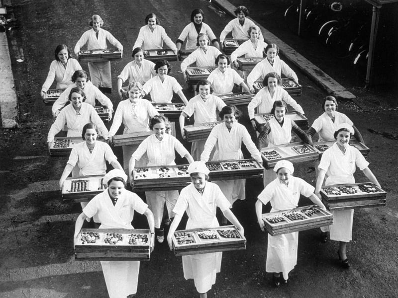 Workers at a Bedford sweet factory holding trays of Christmas chocolates in November 1937