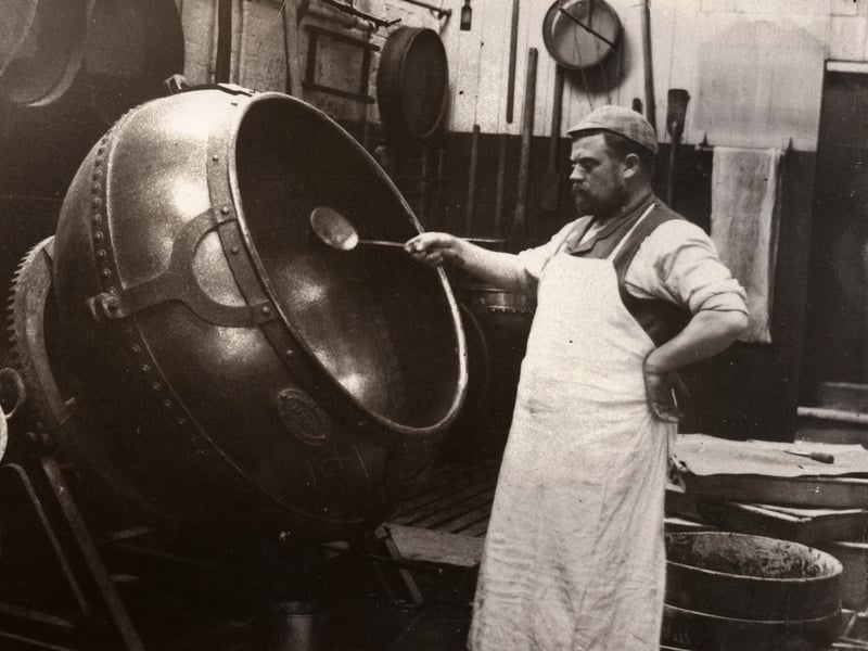 A man in an apron panning chocolate at Rowntree Cocoa Works, York, in 1900