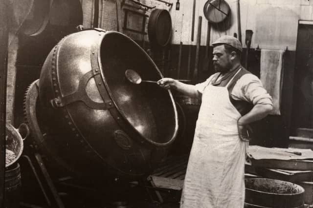 A man in an apron panning chocolate at Rowntree Cocoa Works, York, in 1900