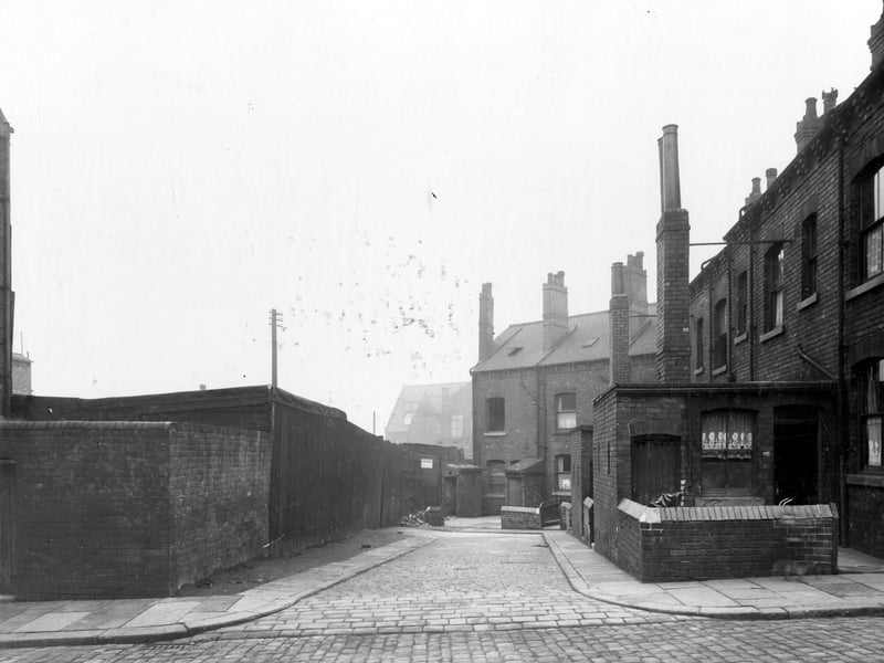 Back Temple View Road in November 1938. It was located off York Road. This view shows brick houses with outside toilets. On the right, back door into scullery or kitchen, the toilet is the door to the left.