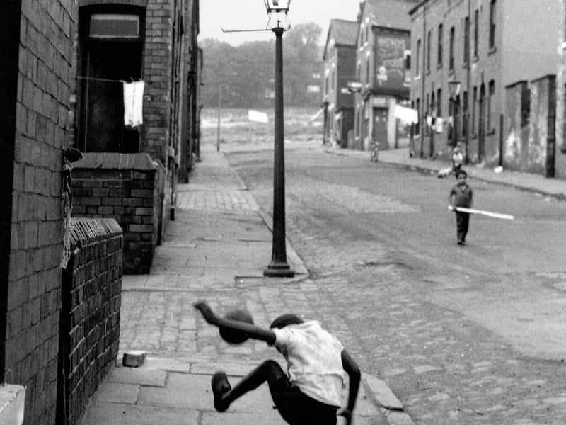 Westfield Crescent looking towards Woodsley Road. Behind the young boy practicing his football skills is the junction with Rosebank Street.