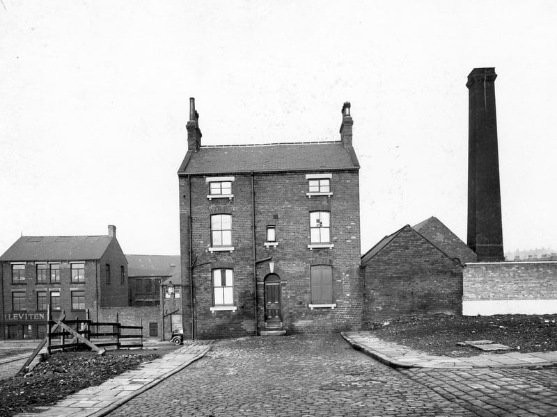 A unknown street leading up to house in Cromwell Street in November 1938. In the background is M. Leviten, rag merchants, 23a Macaulay Street. Factory chimney to right of photo
