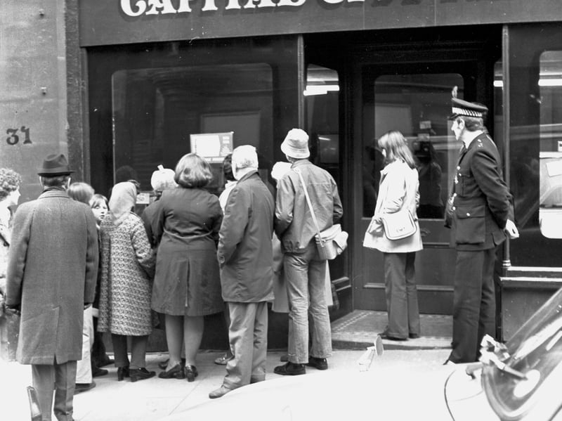 Edinburgh passers-by watch the Royal wedding of Princess Anne and Captain Mark Phillips through the window of a television shop on the Royal Mile in November 1973
