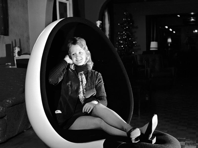 A girl tries out a chair with inbuilt stereo speakers at Jenners department store, Edinburgh, in December 1971
