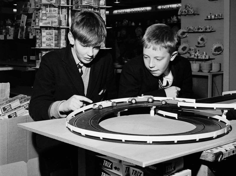 Schoolboys play with a slot-car racing set called Trix in the toy section of Binns department store, Edinburgh, in November 1965