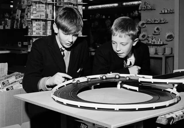 Schoolboys play with a slot-car racing set called Trix in the toy section of Binns department store, Edinburgh, in November 1965