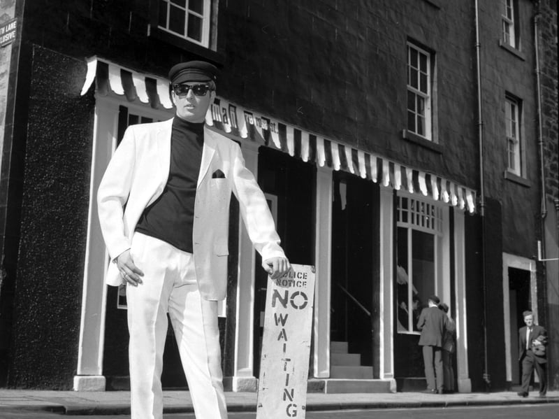 Modelling a pure white Italian suit, some of the trendy gear on sale at Our Man, an Edinburgh clothes shop on Rose Street, in May 1966.