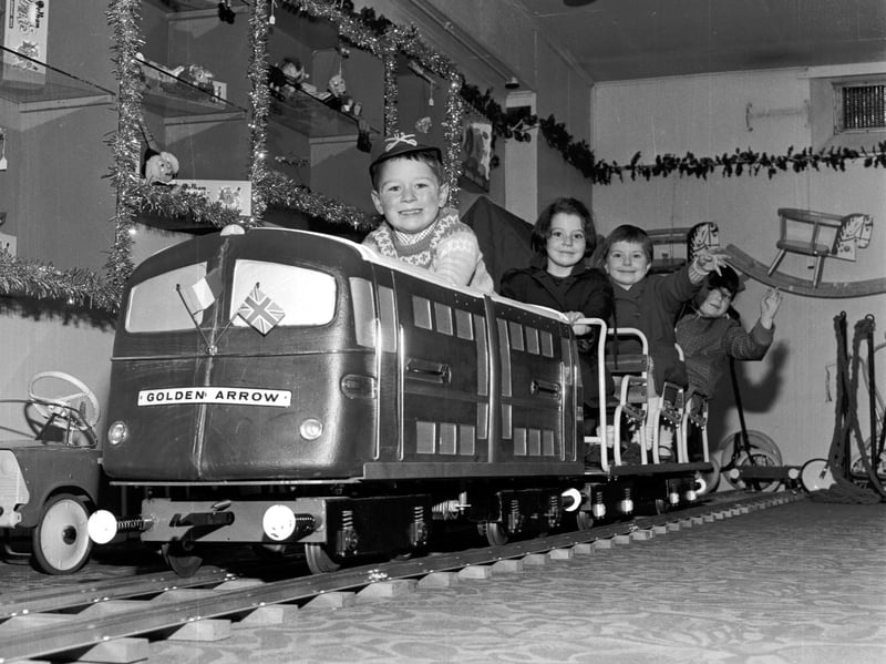 Children play on the model of the Golden Arrow engine at Jenners department store, Edinburgh, in November 1965