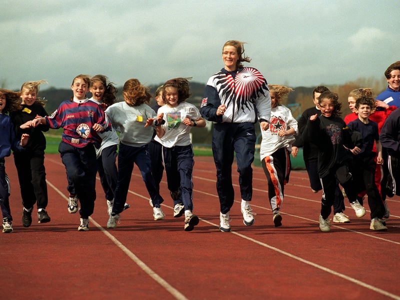Great Britain 800m runner Michelle Faharty, centre, tutors youngsters on the Beckett Park athletics track.