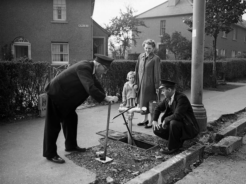 Men reduce the pressure of the water at Saughton Mains Road during a water shortage in October 1959.