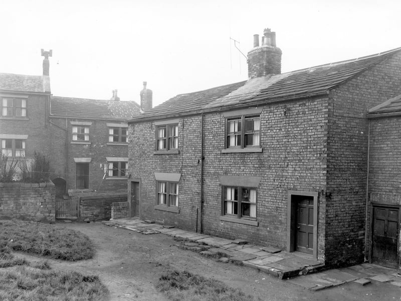 Theaker Lane in November 1957. The photo shows through by light terraced houses numbers 56 and 58. Theaker Lane is on the right with a garden area at the front. On the far left is number 60, another through by light with garden where clothes hang on a line stretched across the yard.