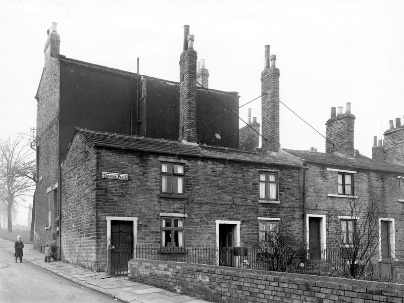 Theaker Place in November 1957. Each house has a large private garden visible on the right of the wall. On the left of the image is Theaker Lane where a group of young boys attempt to climb in the window at the side of number 29 Far Fold.