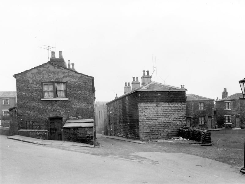 This photo from November 1957  shows in the foreground Theaker Lane leading off to the left. Visible in the center is the entrance to Winker Green with the entrance to Ellis Square on the right.