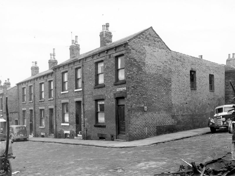 A row of back-to-back terraced houses on Winker Green pictured in November 1957. On the far left a car reg: AFR 836 is parked outside number 18. This area was soon to be demolished under a Leeds City Council slum clearance programme.
