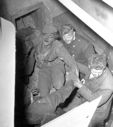 This photo from April 19864 shows Lance Ash being rescued from the 130ft chimney at the warehouse.