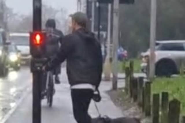 A cyclist on the pavement near Bramall Lane, Sheffield.