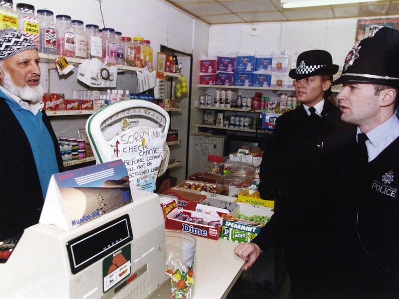 Bobbies on the beat catch up with a shop owner.
