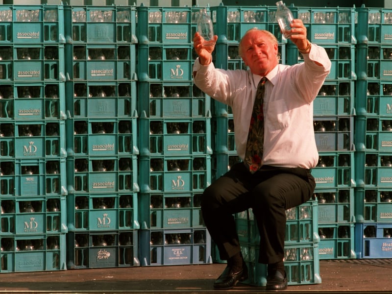 Colin Hall, chairman of M.D. Foods, pictured in August 1994, surrounded by crates of milk bottles.