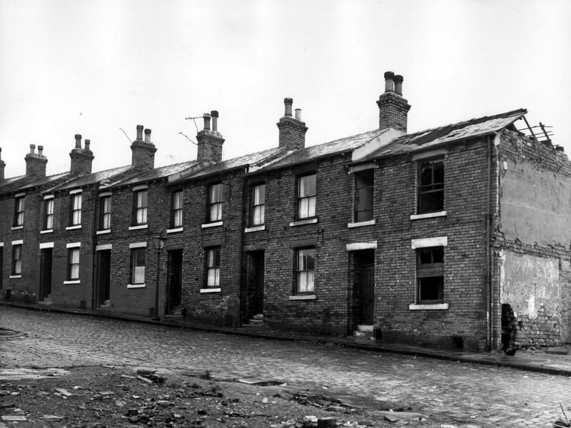 Looking across Woodsley Grove, in the foreground is a cleared site, this would have been Verdun Street. Number 14 Woodsley Grove is on the left, moving right, numbers follow in descending order to 4 which is derelict. On the right edge number 2 has previously been demolished. Pictured in November 1963.