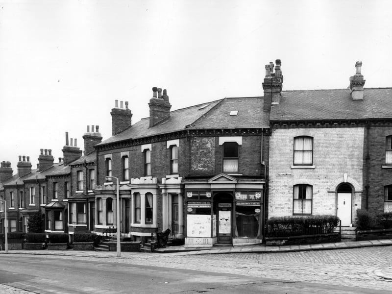 On the left is Woodsley Road, number 41 is at the left edge. Moving right numbers follow in sequence to 55 which is the last house before the shop. This was a former shoe repair business, number 55a. Victoria Mount begins to the right with number 1. All these properties went through to Back Osborne Street. Pictured in November 1963.