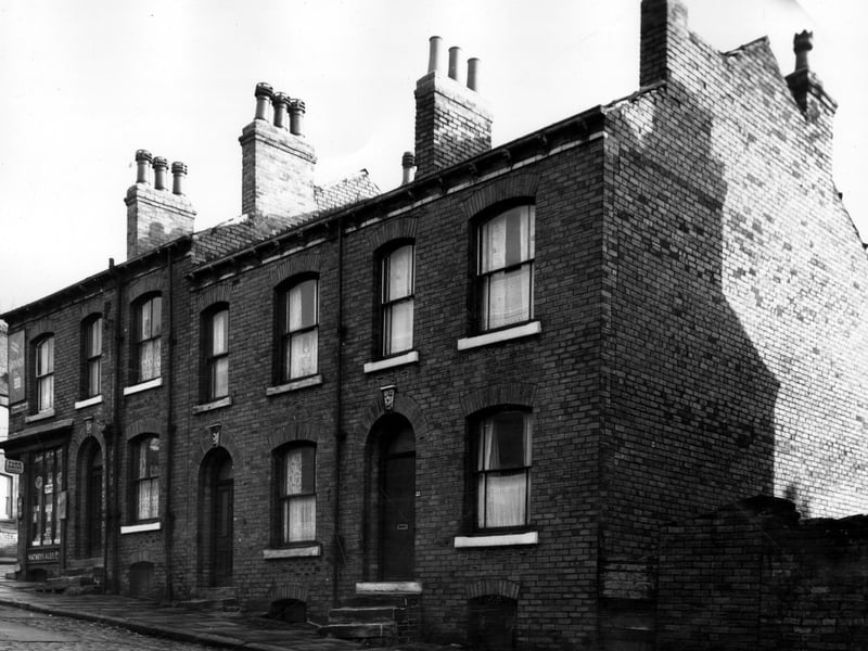 To the left is the junction of Osborne View and Osborne Street. Number 28 at the corner is an off licence and grocers shop. Moving right are 26, 24 and 22. Pictured in November 1963.