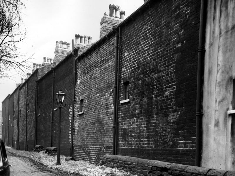 St Johns Grove, looking along back walls of houses on Woodsley View in November 1963.