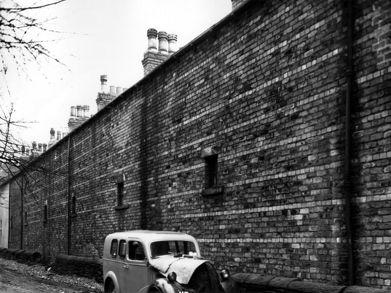 St Johns Grove with rear walls of houses which fronted onto Woodsley View. Pictured in November 1963.