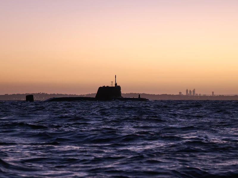 HMS Anson preparing to enter HMAS Stirling with Perth in the background.