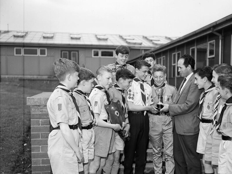 The Boy Scouts football team of 143rd Liberton are presented with a cup by Third Lanark's Jockie Robertson in June 1963.