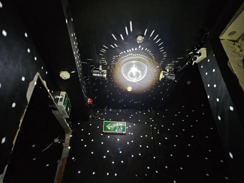 A disco ball remains intact at the bottom of the staircase.