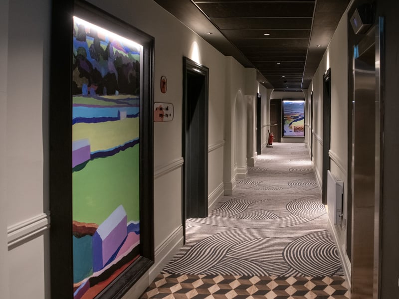 Corridor with artwork of Yorkshire scenes.