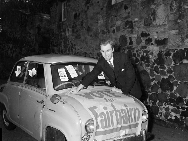 Conservative candidate Nicholas Fairbairn with poster on his Goggomobil car during the Craigmillar by-election campaign in November 1959.