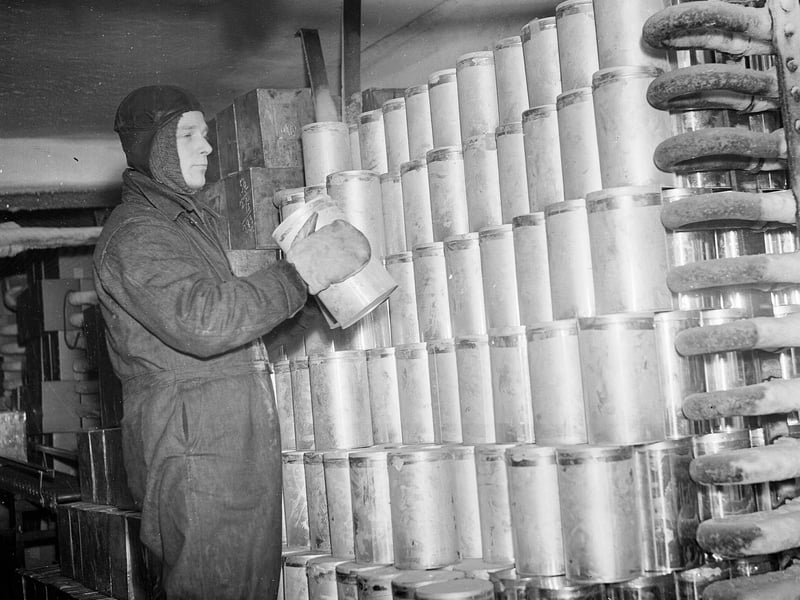 Mr F. Mackenzie is wrapped up well to work in the storage room of the Walls Ice Cream Factory, Craigmillar, in March 1955.