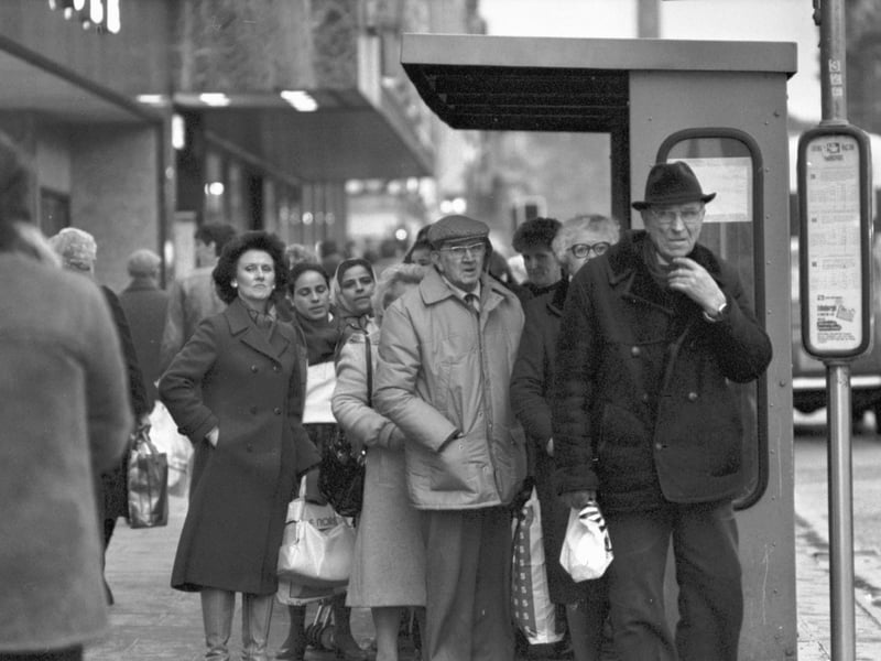People standing at a Lothian Region Transport (LRT) bus stop on Princes Street, Edinburgh, in January 1986.