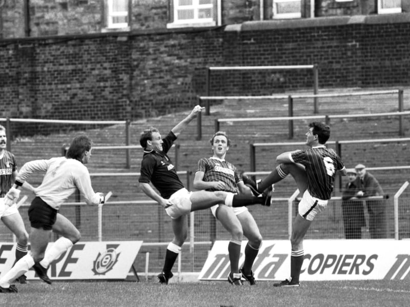 Hearts' Sandy Clark and Falkirk's Jim Dempsey in action during a match at Tynecastle in August 1986