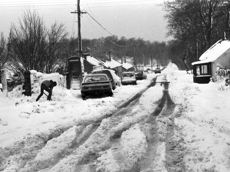 Residents clear snow from the road at Silverburn near Penicuik, Midlothian, in April 1986