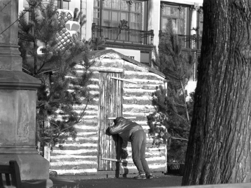 A child tries to see inside the boarded-up Santa's Grotto at the Princes Street gardens, Edinburgh, after Christmas Day in December 1986